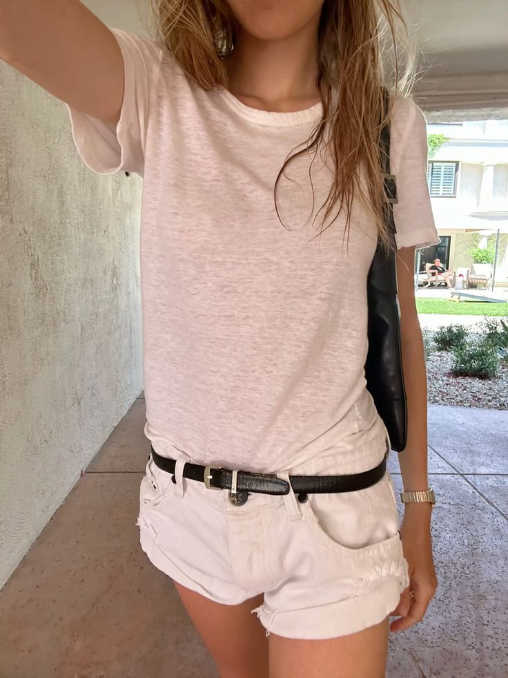 Woman in a white tee and white shorts showing how a stripped-down outfit can still read precise when the edit is deliberate